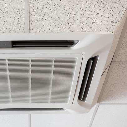 Ceiling mounted large air-conditioner in office, close up view