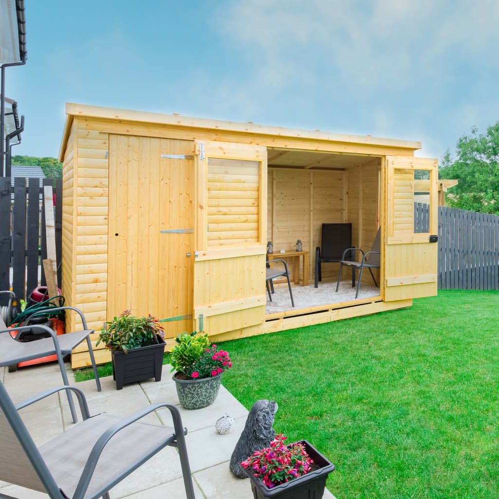 A newly completed and replanted landscaped garden with new laid turf grass, a new patio and garden ornaments surrounded by new erected wooden fencing all to a modern design and painted slate blue. A newly erected summer house , garden room in natural stained cabin finished wood. A good image for a landscape gardener designer or garden retail centre